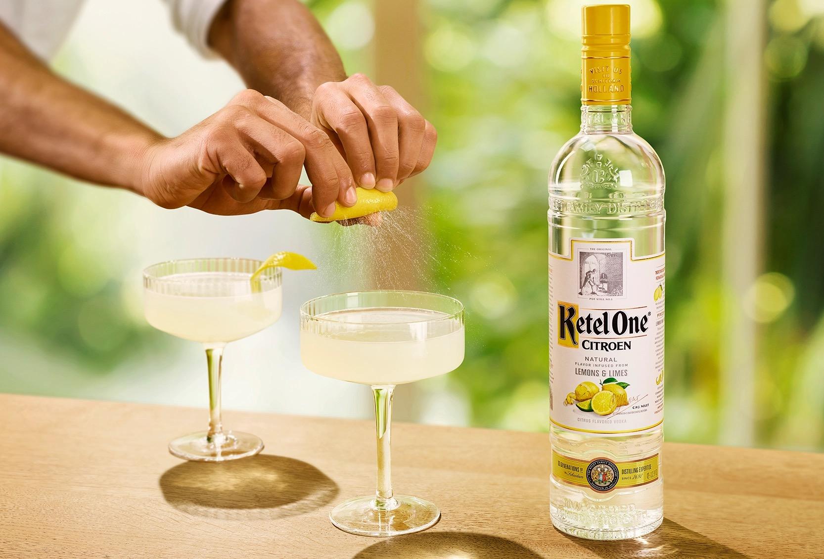 Ketel One Lemon Drop Martini in Coupe Glass with hand adding lemon spritz