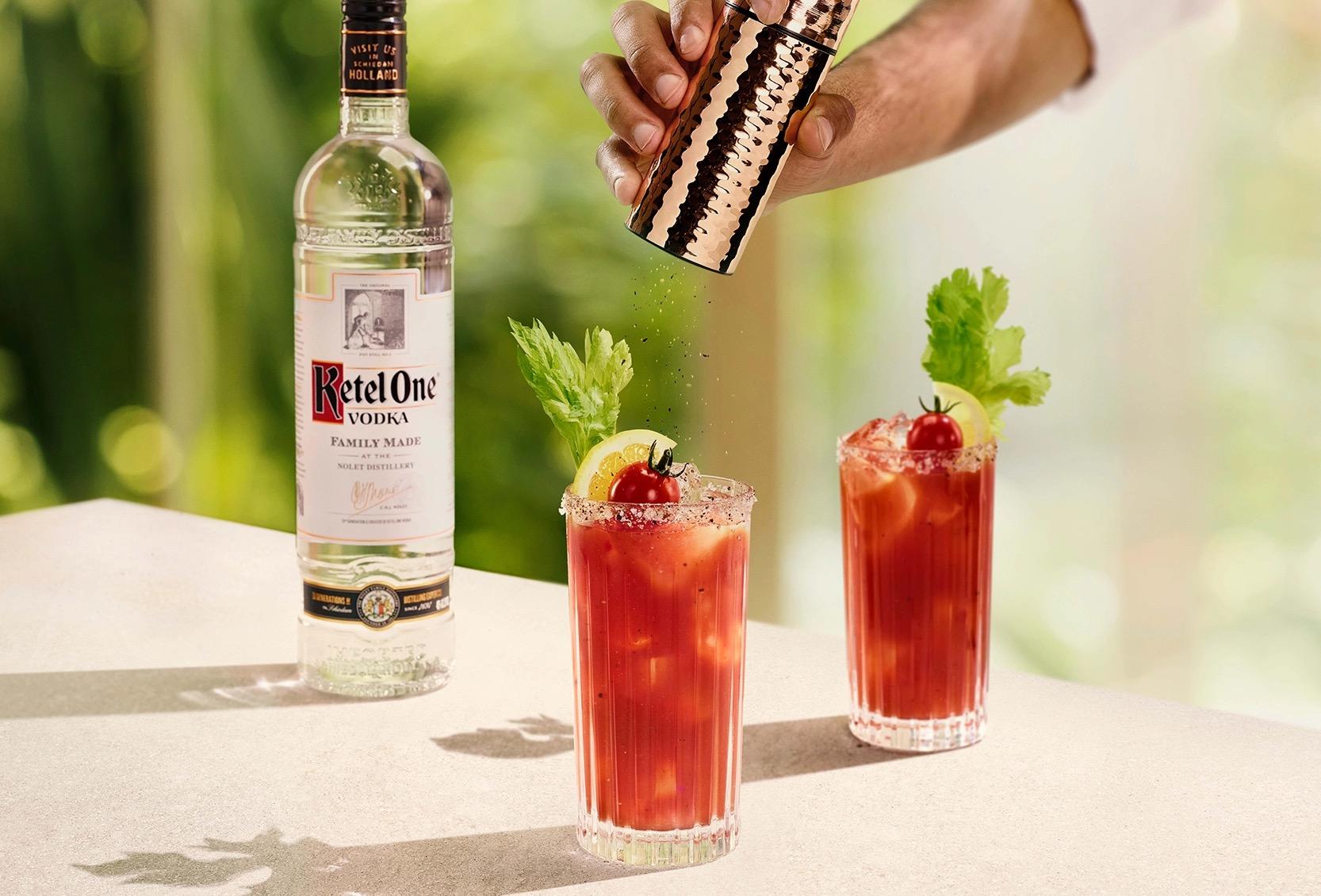 Ketel One Bloody Mary in High Ball Glass with hand grinding pepper