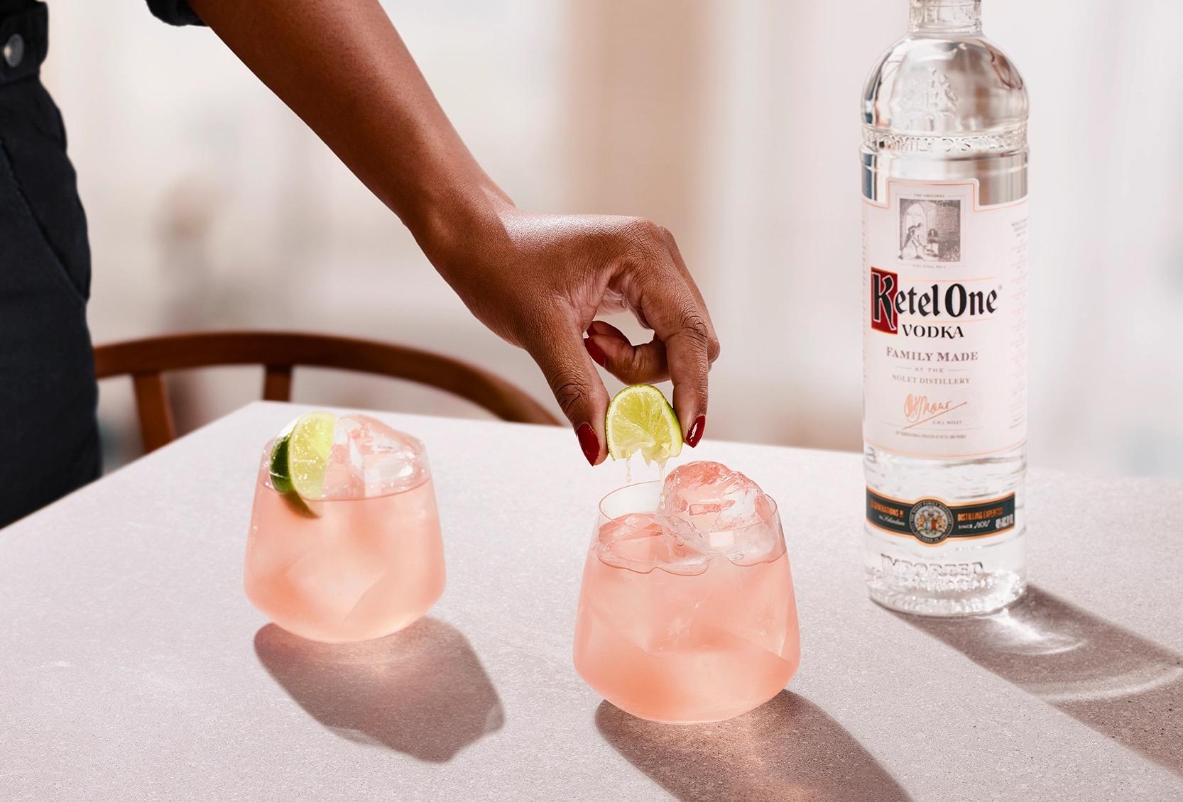 Ketel One Sea Breeze in Rocks Glass with hand adding lime spritz