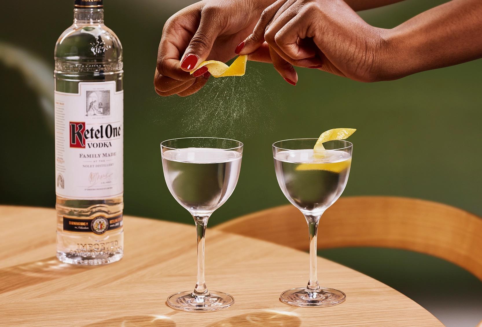 Ketel One Dry / Classic Martini in Nick and Nora Glass with hand adding lemon spritz
